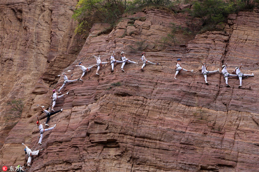 Entusiastas del Yoga practican en el acantilado de una gran monta?a