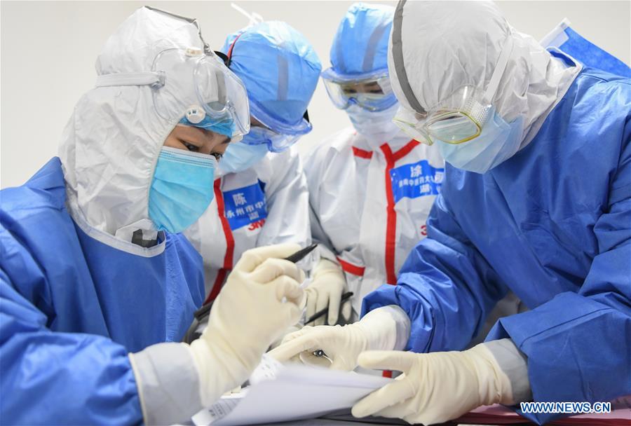 WUHAN, 14 febrero, 2020 (Xinhua) -- Trabajadores médicos revisan la información de los pacientes en el hospital provisional Jiangxia, en Wuhan, ciudad capital de la provincia de Hubei, en el centro de China, el 14 de febrero de 2020. El hospital provisional Jiangxia, un hospital de 400 camas convertido de un centro deportivo al aire libre, comenzó a recibir pacientes con neumonía COVID-19 con síntomas leves el viernes. El hospital es el primer hospital provisional que adoptará principalmente el tratamiento de medicinas tradicionales chinas para curar a los pacientes. (Xinhua/Cheng Min)