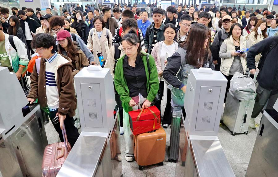 Imagen del 6 de octubre de 2024 de pasajeros cruzando las barreras de entrada en la Estación de Ferrocarriles de Qinhuangdao, en la provincia de Hebei, en el norte de China. (Xinhua/Cao Jianxiong) 